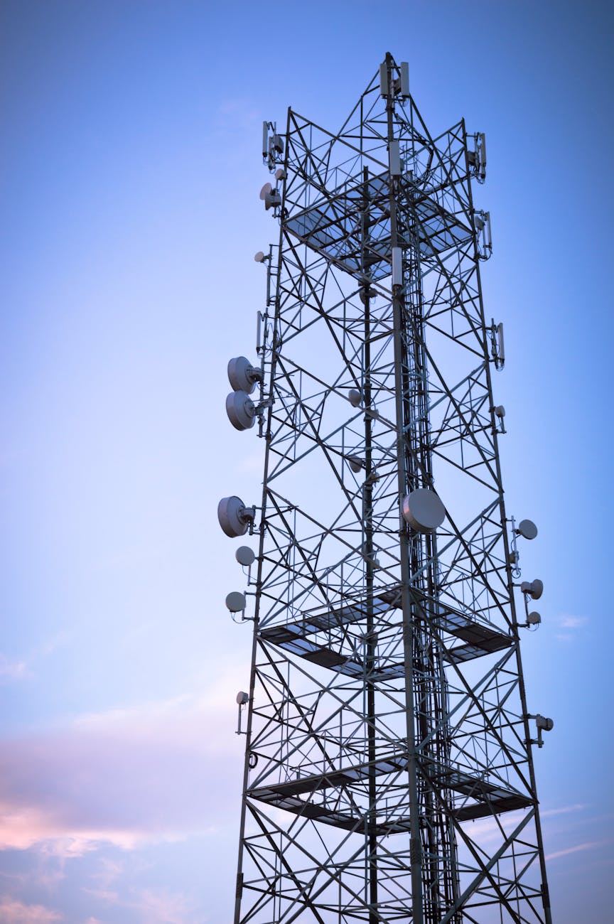 modern telecommunications tower against blue sky